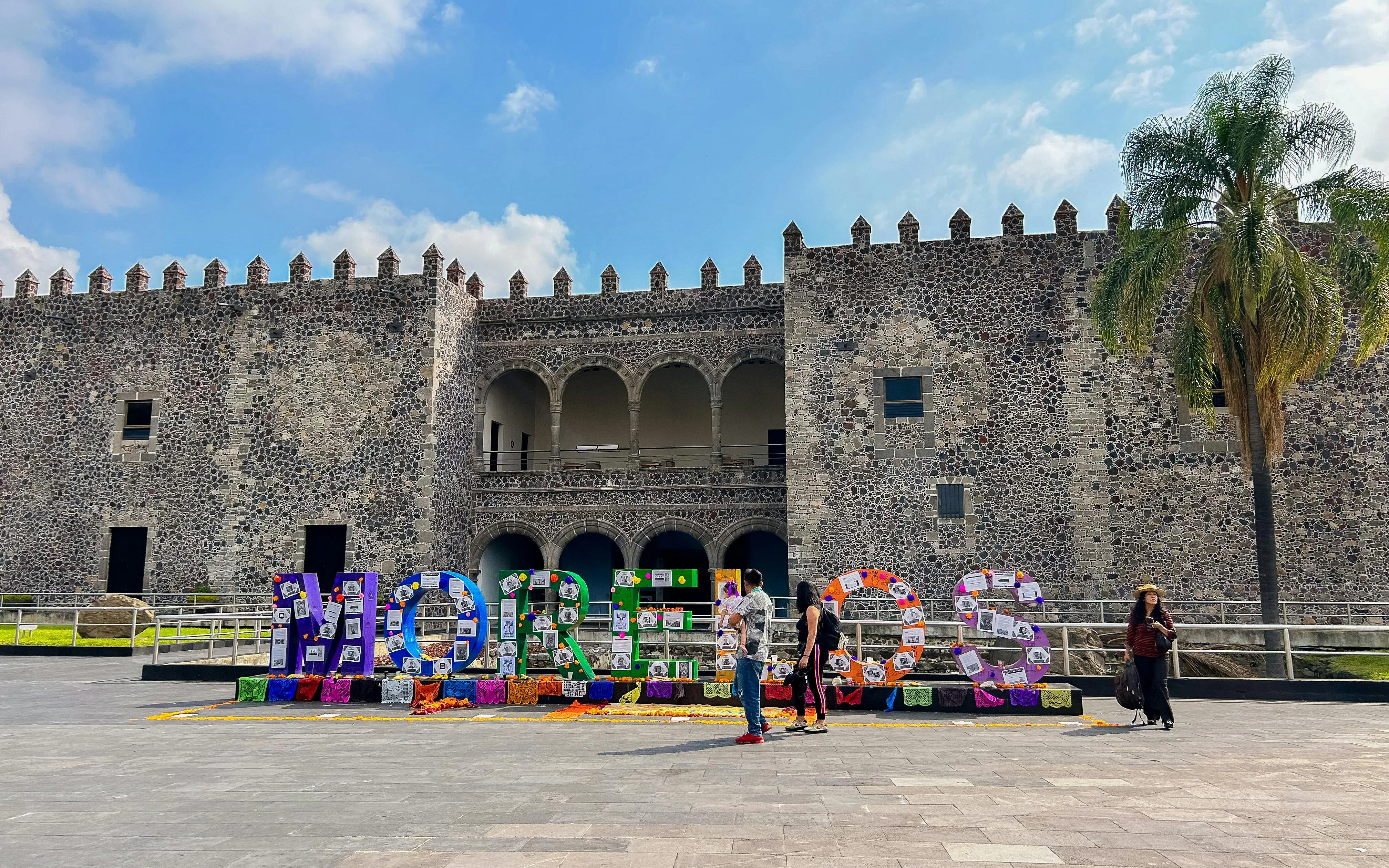 Cuernavaca's Palacio de Cortés with colorful "Morelos" sign in front, Mexico City tour.