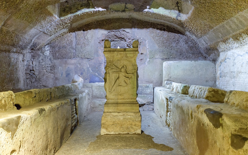 Mithraeum altar under Basilica of Saint Clement, Rome, Italy, with ancient stone benches.