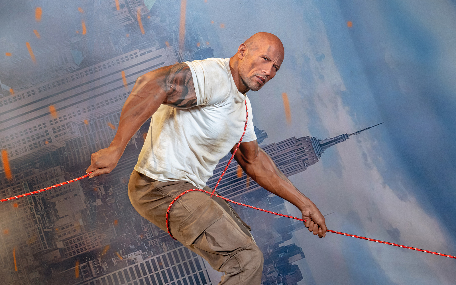 Wax figure of Dwayne Johnson holding a rope at Madame Tussauds Orlando.