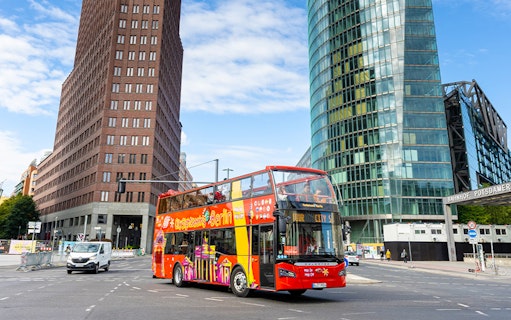 Red double-decker bus on Berlin Hop On & Hop Off tour at Potsdamer Platz.