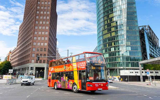 Red double-decker bus on Berlin Hop On & Hop Off tour at Potsdamer Platz.