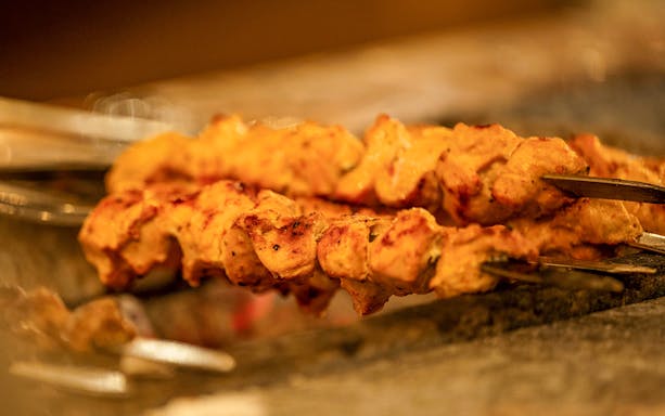 Grilled chicken skewers on a Dubai Creek luxury dhow dinner cruise.