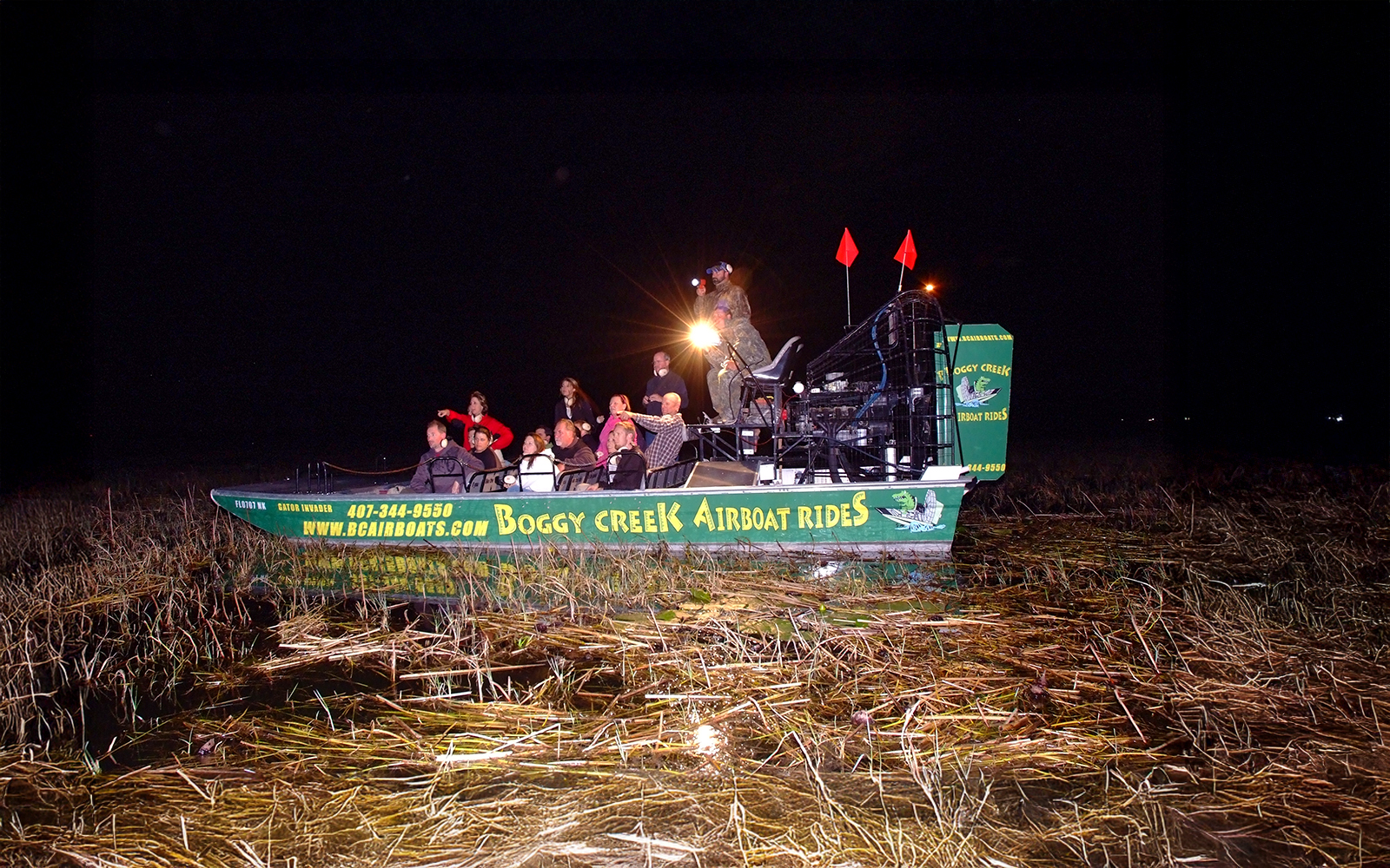 Group on an airboat during a night tour at Boggy Creek in Orlando.