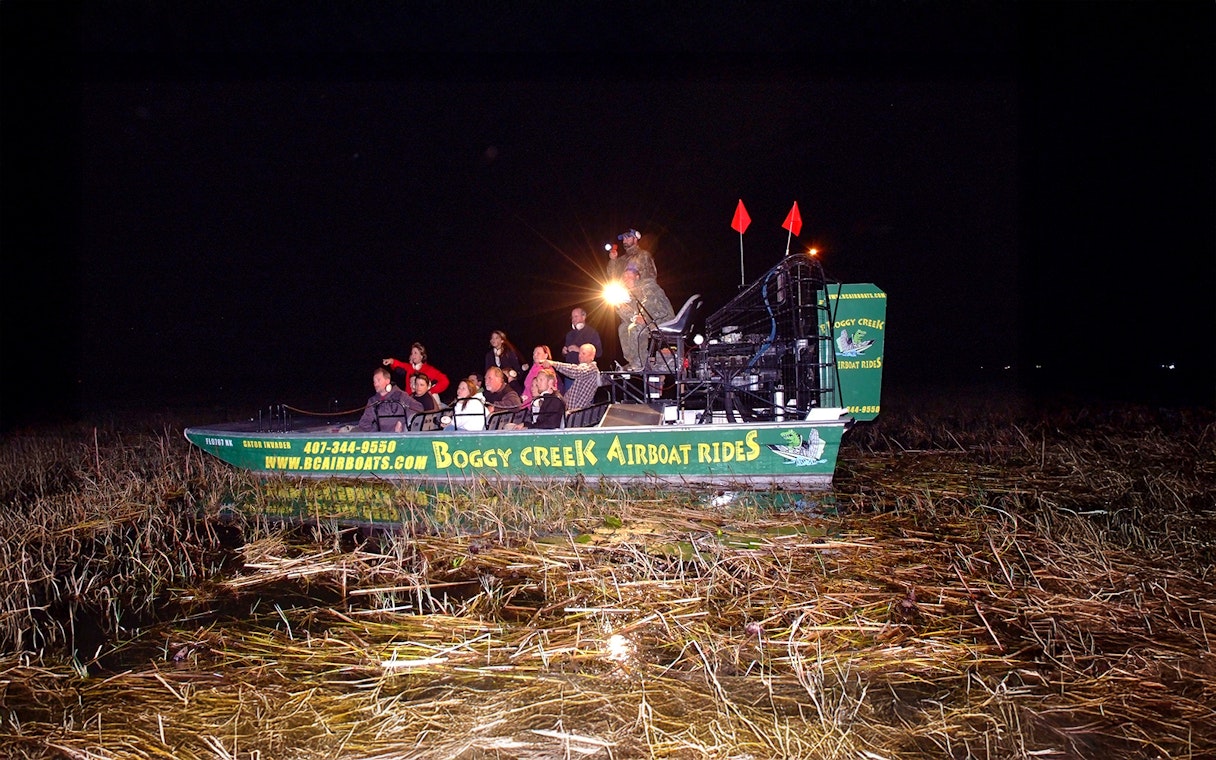 Group on an airboat during a night tour at Boggy Creek in Orlando.