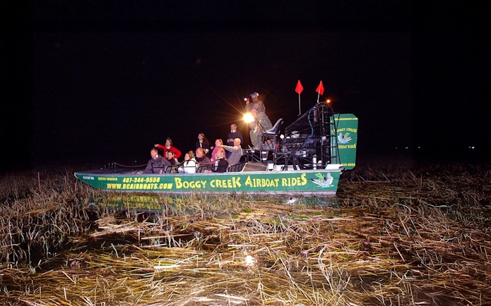 Group on an airboat during a night tour at Boggy Creek in Orlando.