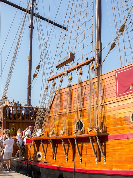 Tourists boarding a wooden ship for a guided Elaphite Islands cruise.