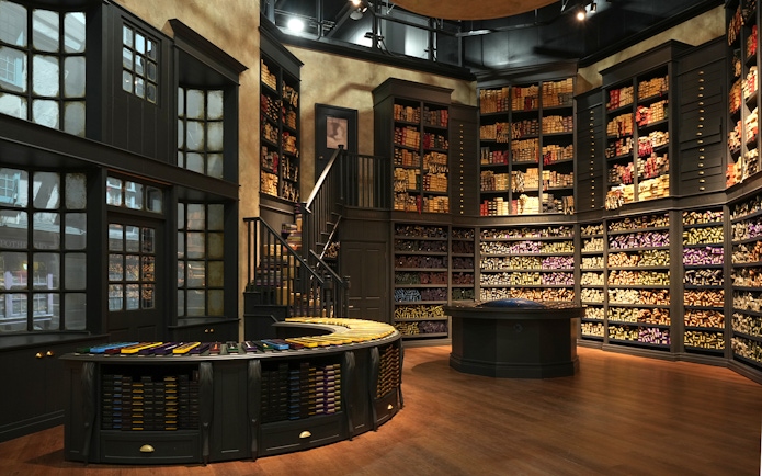 Wand shop interior at Warner Bros. Studio Tour Tokyo, showcasing shelves filled with wand boxes.