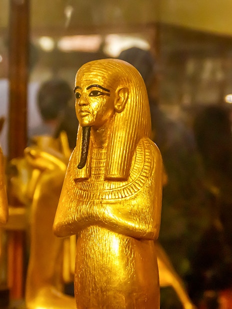 Golden statues of ancient Egyptian figures at the Egyptian Museum of Antiquities.