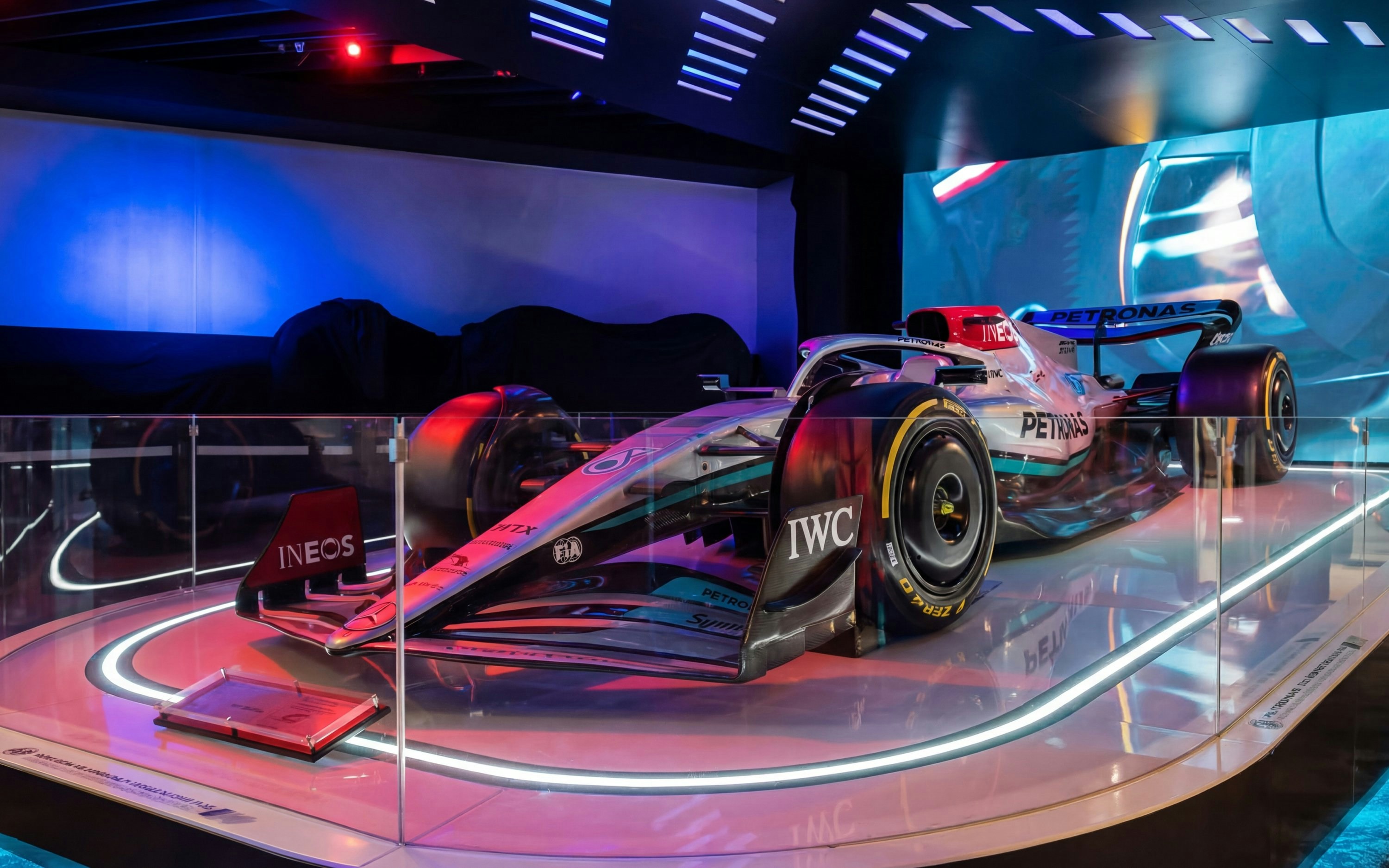 F1 car display at Petrosains, featuring sleek design and vibrant lighting.