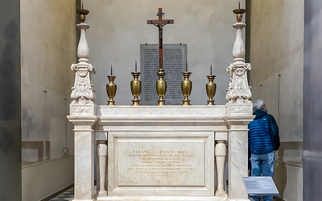 Altar in the New Sacristy of the chapel with ornate candlesticks and a crucifix.