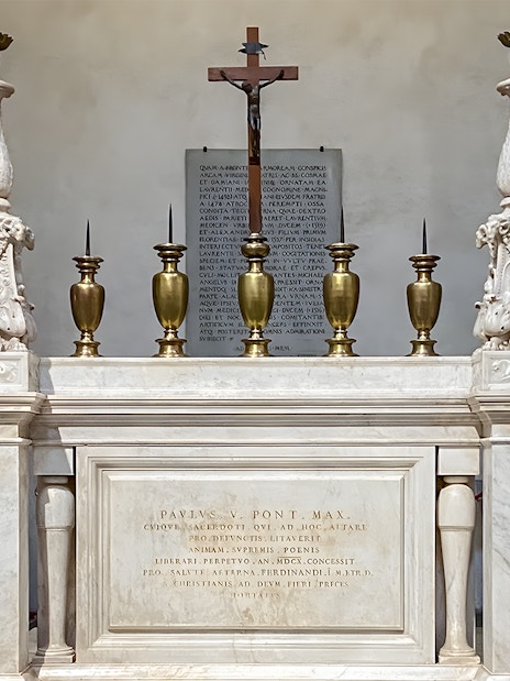 Altar in the New Sacristy of the chapel with ornate candlesticks and a crucifix.