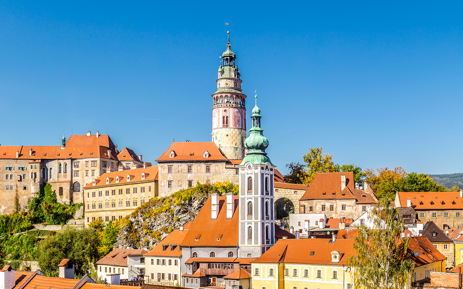 Castle of Cesky Krumlov with colorful buildings and tower in South Bohemia.