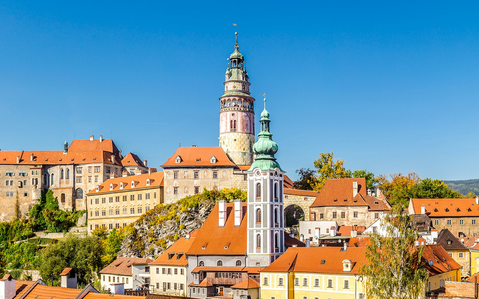 Castle of Cesky Krumlov with colorful buildings and tower in South Bohemia.