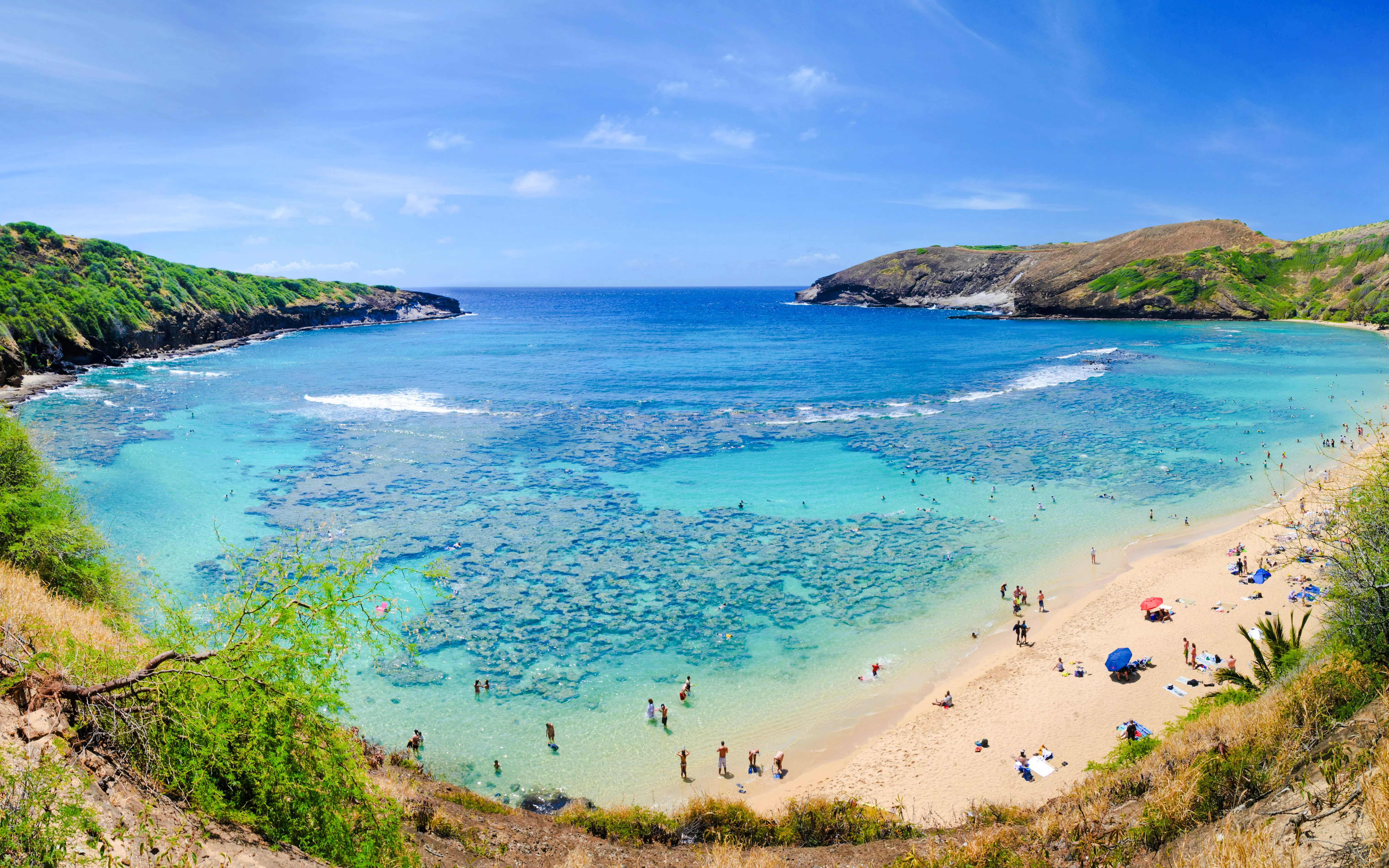 Hanauma Bay beach with swimmers and coral reef, Oahu, Hawaii.