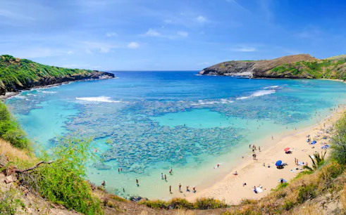 Hanauma Bay beach with swimmers and coral reef, Oahu, Hawaii.
