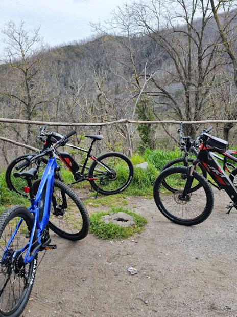 E-bikes parked on a trail with Mount Vesuvius in the background during a guided tour from Sorrento.