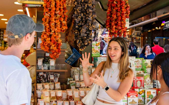 Tour guide explaining spices at Istanbul market during food tour.