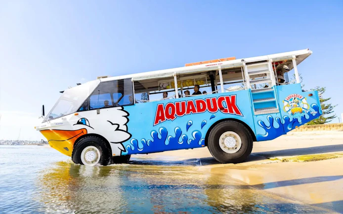 Aquaduck amphibious vehicle entering water on Sunshine Coast city tour and river cruise.