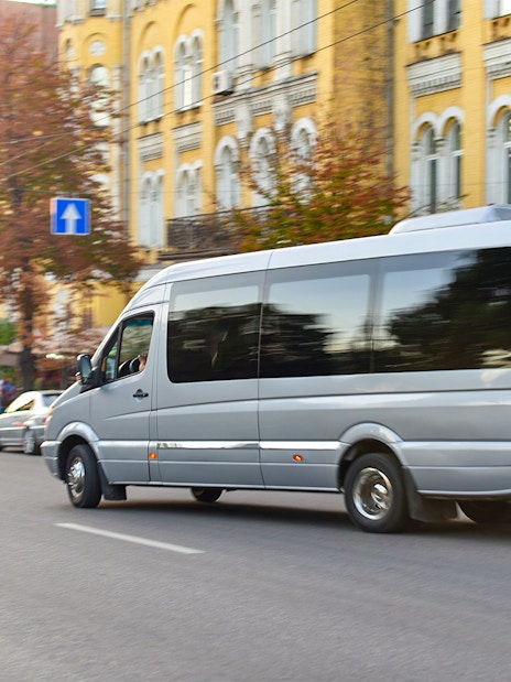 Minivan on city street for private transfer to Gatwick Airport.