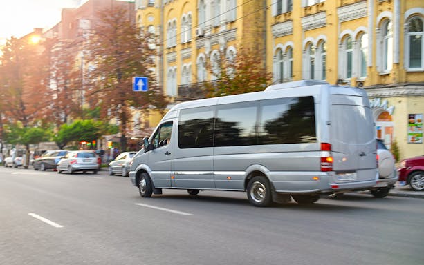 Minivan on city street for private transfer to Gatwick Airport.