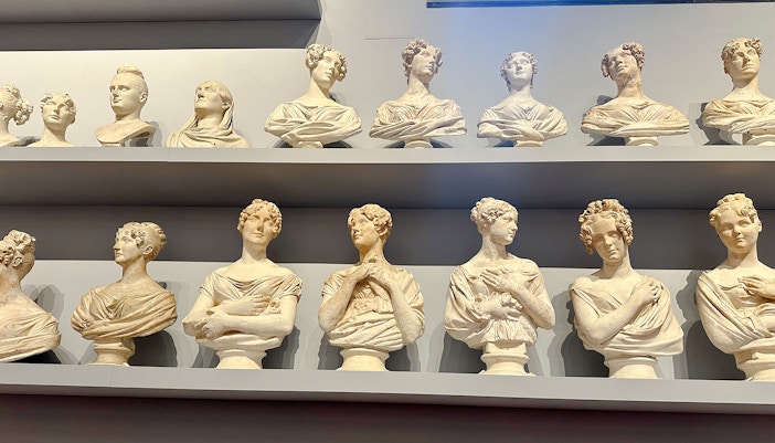 Bust sculptures displayed on shelves in Accademia Gallery, Florence.
