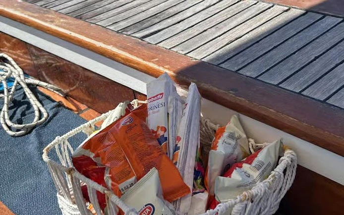 Basket of local snacks on a boat deck during Capri tour.