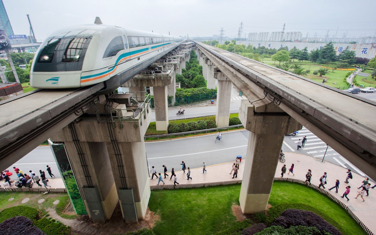 Shanghai Maglev Train on elevated tracks above a busy street in Shanghai, China.