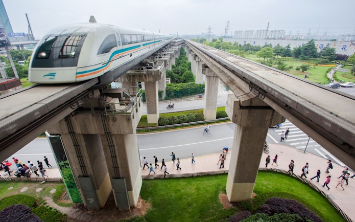 Shanghai Maglev Train on elevated tracks above a busy street in Shanghai, China.