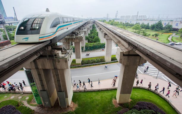 Shanghai Maglev Train on elevated tracks above a busy street in Shanghai, China.