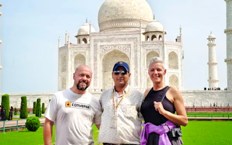 Tourists with guide in front of the Taj Mahal, Agra, during a guided tour.