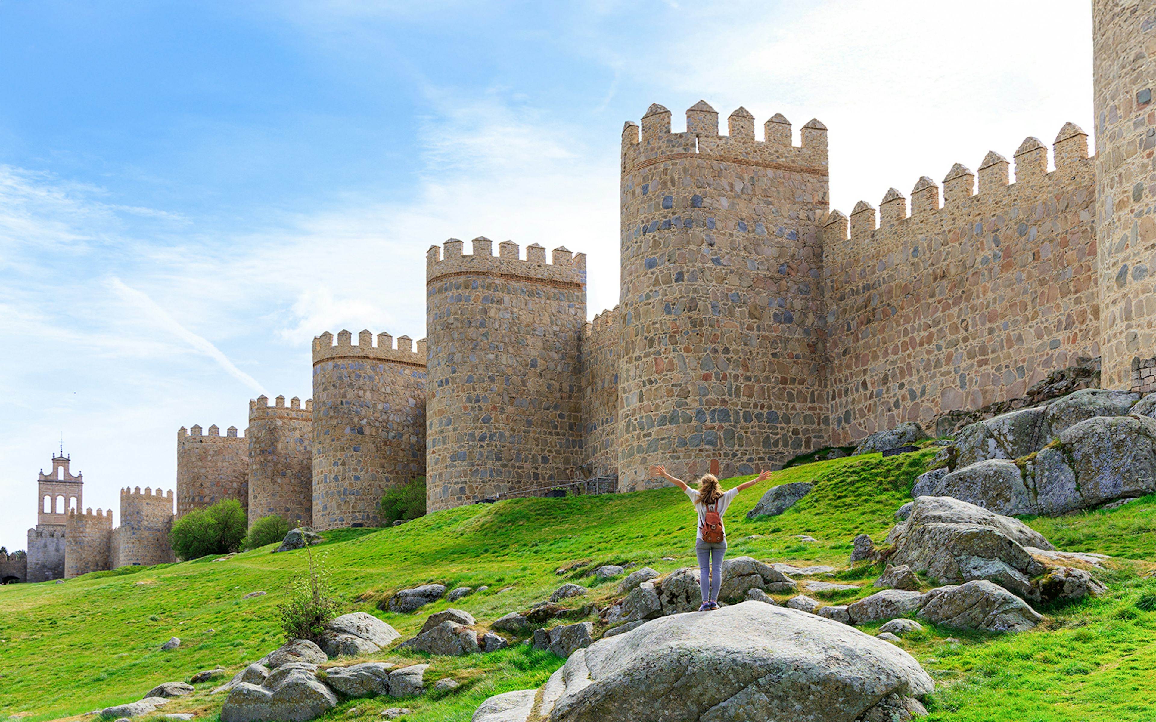 Tourists admiring the Medieval city walls of Ávila, Spain.