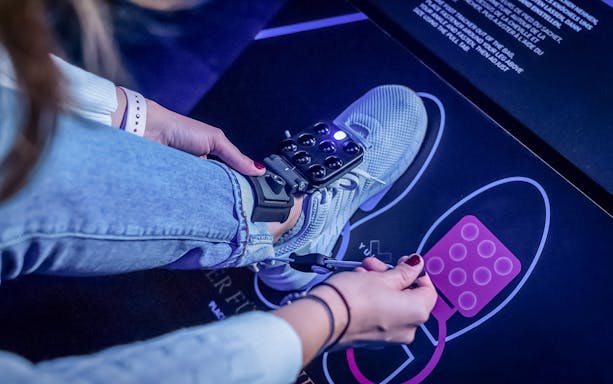 VR sensor being attached to a shoe for YULLBE PRO experience.