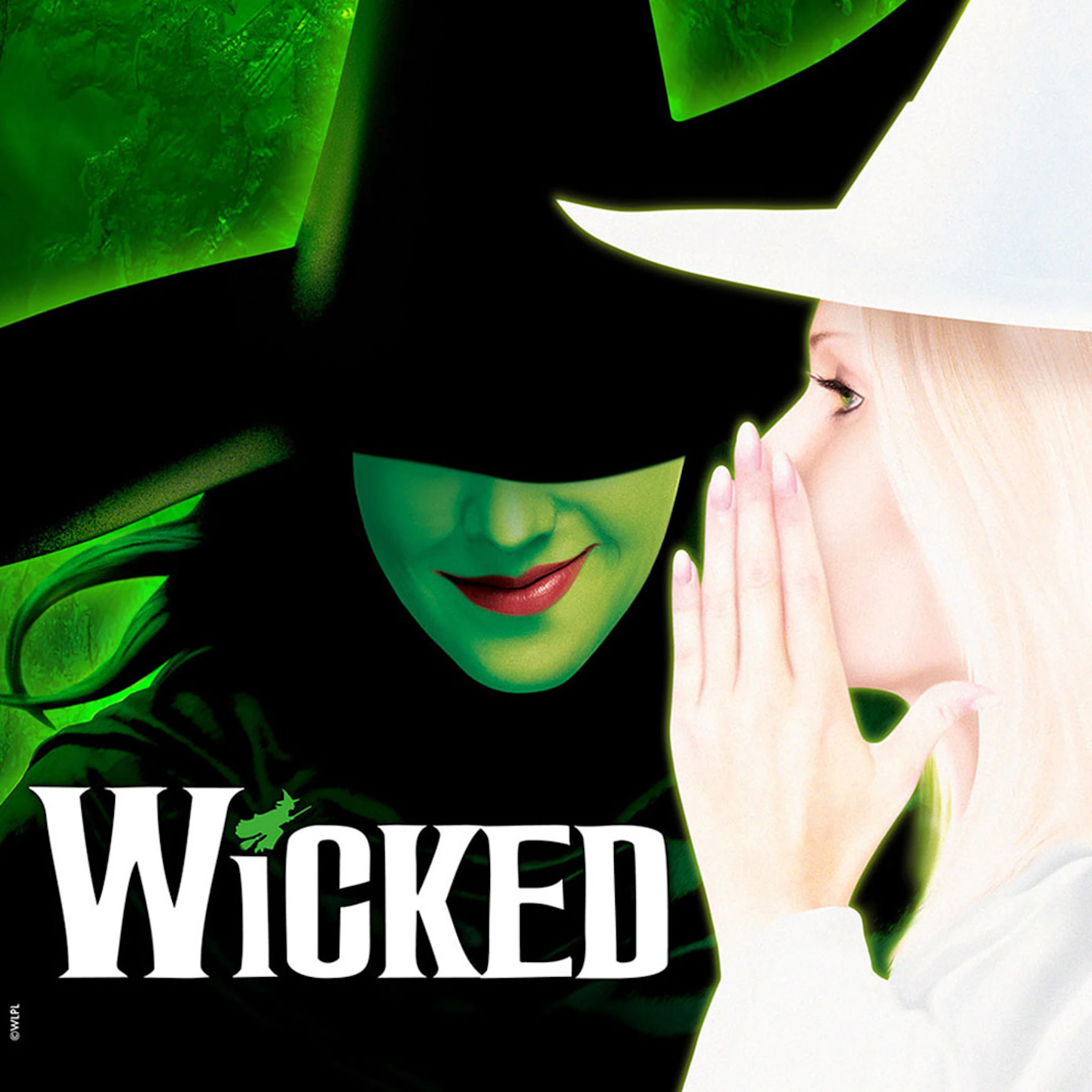 Two characters from the musical Wicked, one in a black hat and the other whispering.
