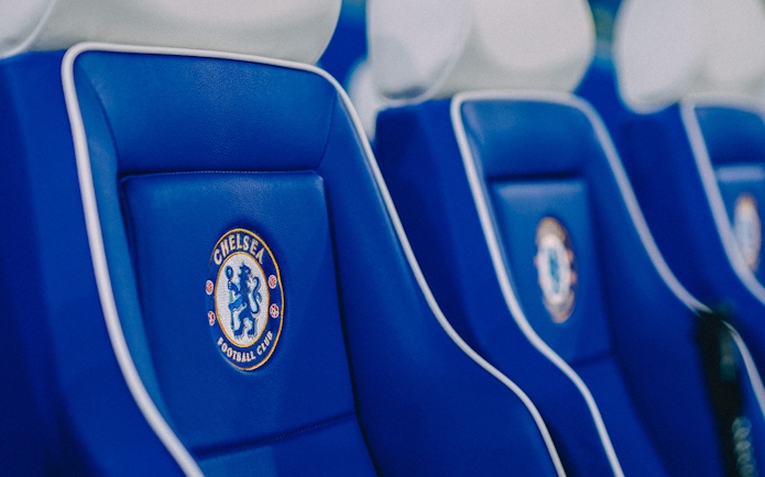 Chelsea FC stadium seats with team logo.