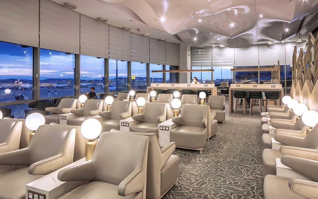 Istanbul Ataturk Airport lounge with seating and view of runway.