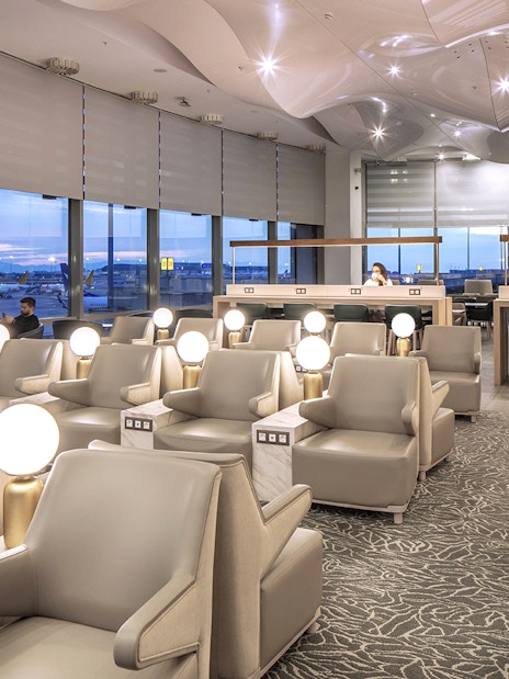 Istanbul Ataturk Airport lounge with seating and view of runway.