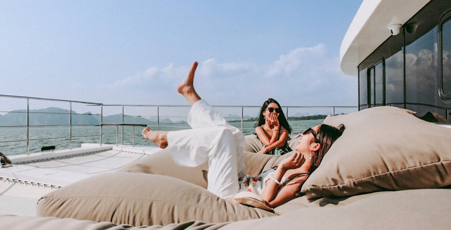 Tourists relaxing on a luxury catamaran en route to James Bond Island.