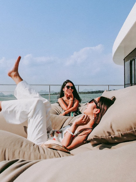Tourists relaxing on a luxury catamaran en route to James Bond Island.