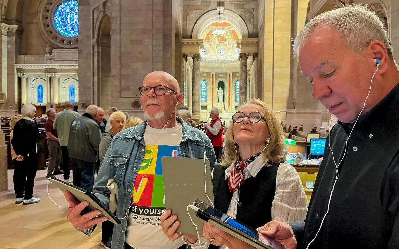 Visitors using audio guides inside St Patrick Cathedral.