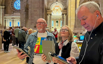 Visitors using audio guides inside St Patrick Cathedral.