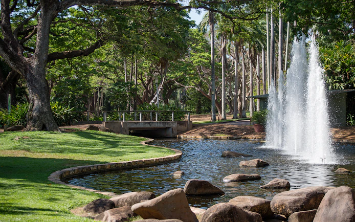 Fountain and lush greenery in a park during a guided half-day city tour of Darwin.