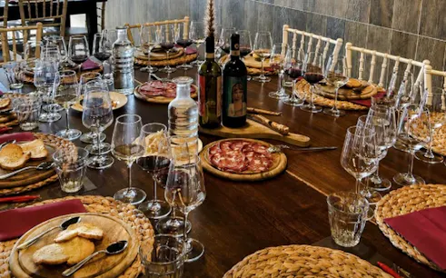 Tuscan wine tasting setup with meats and bread in Florence cellar.