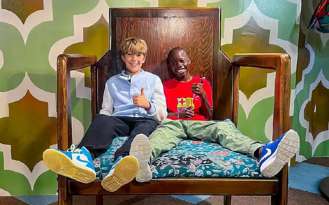 Visitors sitting on oversized chair at Big Fun Museum, Barcelona exhibit.