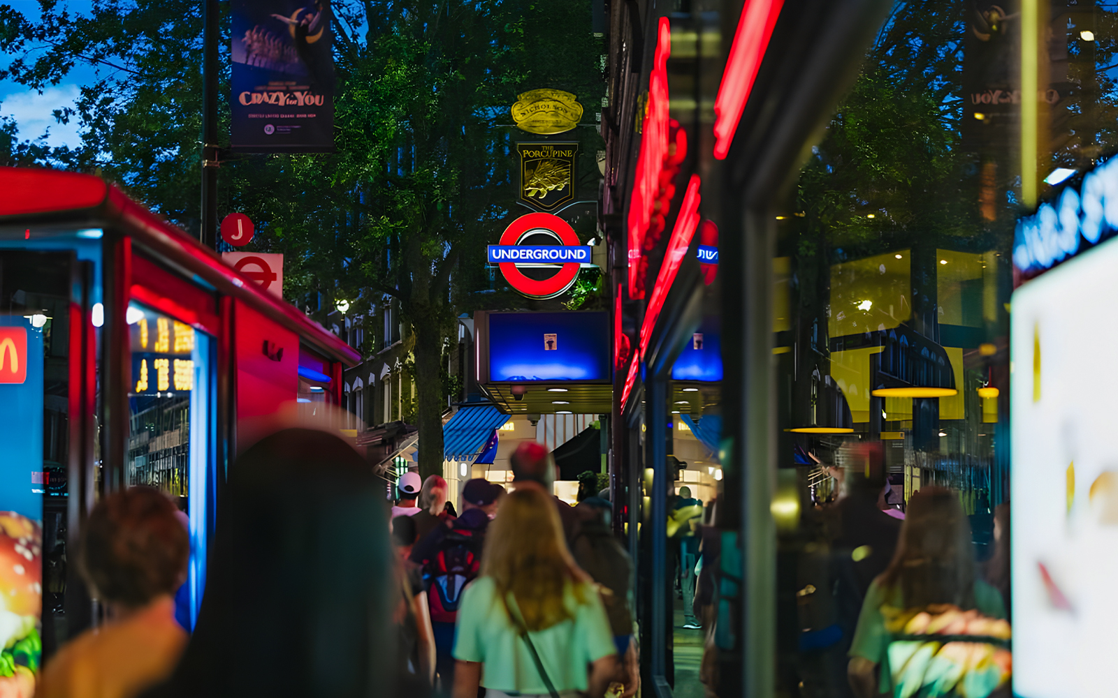 Crowd walking near London Underground sign on Harry Potter film locations tour.