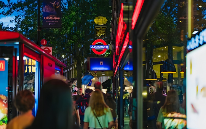 Crowd walking near London Underground sign on Harry Potter film locations tour.