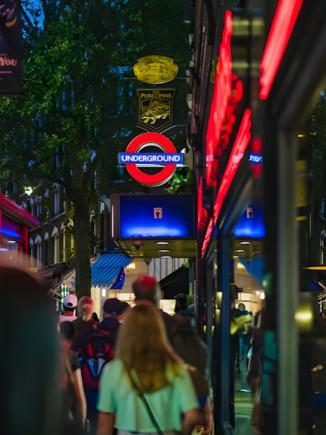 Crowd walking near London Underground sign on Harry Potter film locations tour.