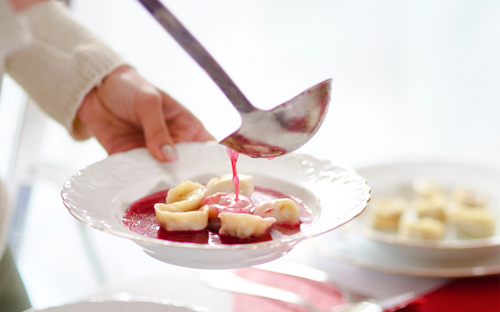 Barszcz soup with dumplings being served in Poland.