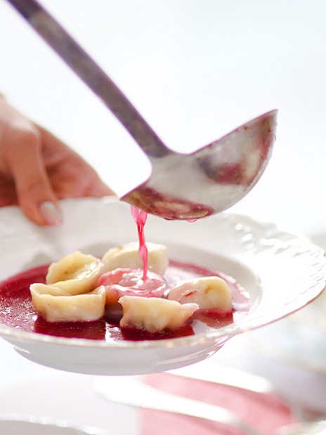 Barszcz soup with dumplings being served in Poland.