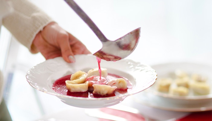 Barszcz soup with dumplings being served in Poland.