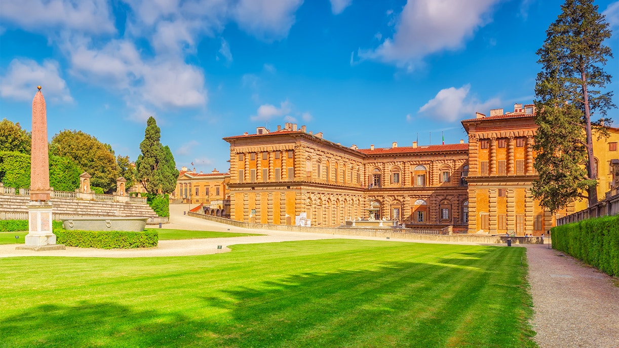 Visitors exploring the historic Boboli Gardens in Florence, Italy, surrounded by lush greenery and classical sculptures.